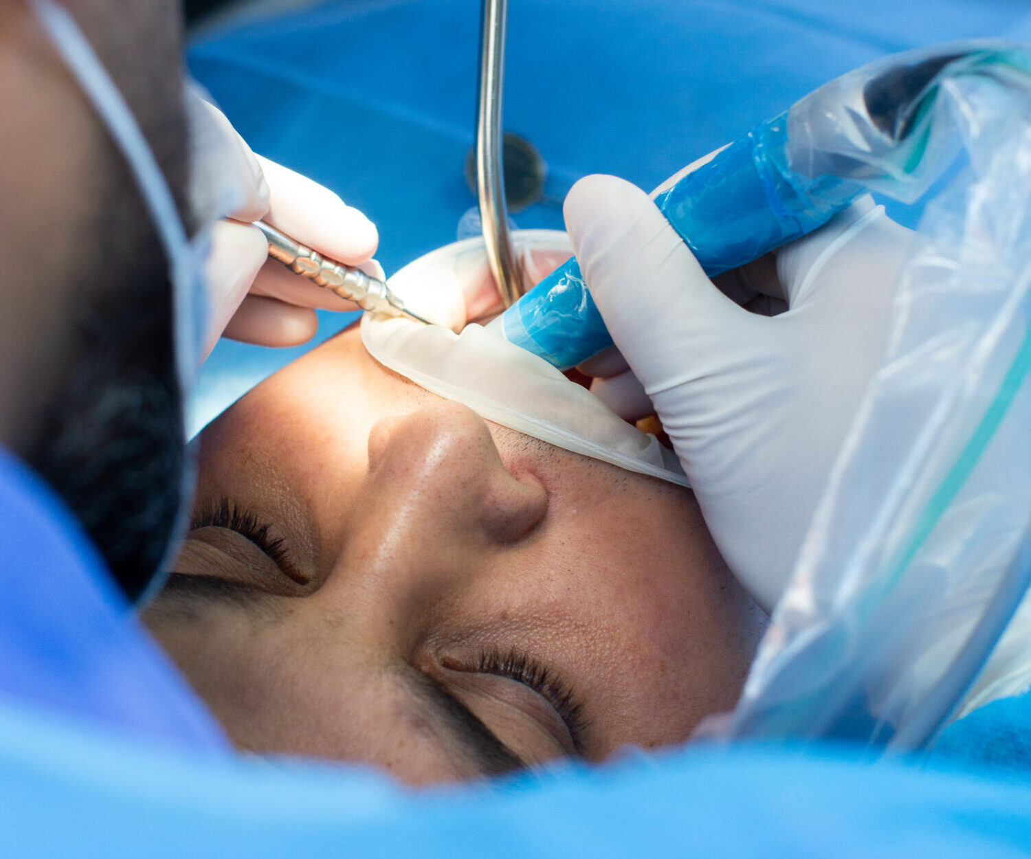 dentist and assistant with tool makes some manipulations in the patient's mouth